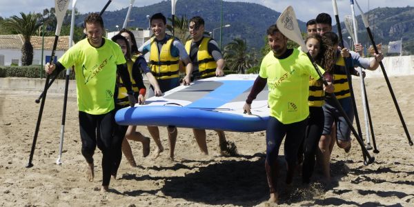 Escolares haciendo paddle surf en la orilla